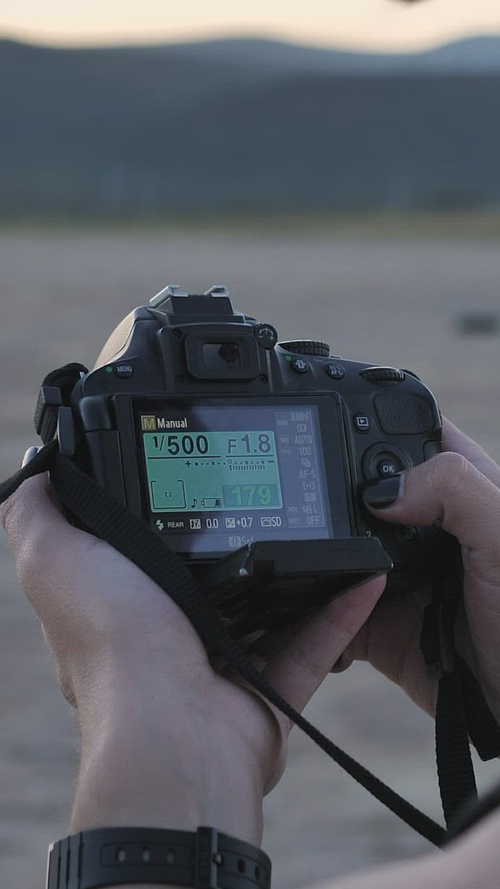 Photographer setting up a camera outdoors before a shoot
