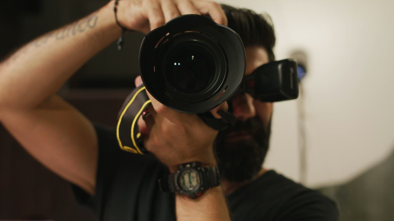 Close view of a camera lens held by a photographer