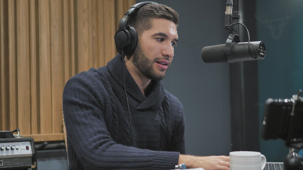Presenter speaking into a studio microphone