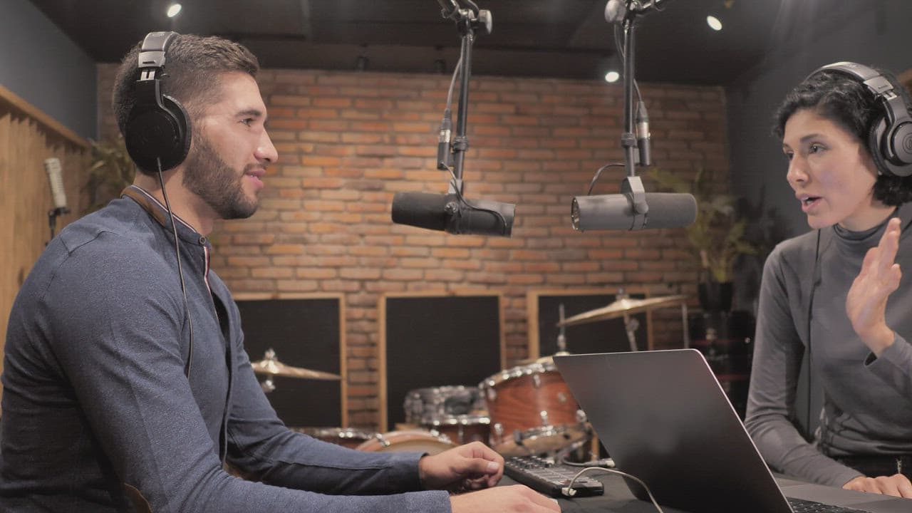 Small team recording a podcast together in a studio