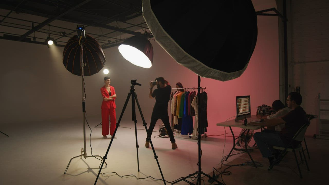 Photographer and creative team producing a studio fashion shoot